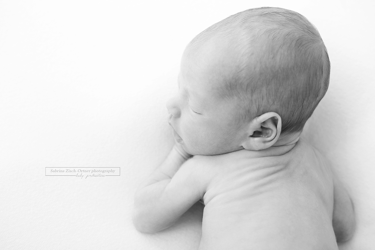 Seitliches Portrait in Schwarz Weiß eines kleinen Babys