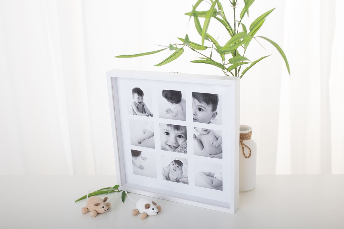 weißer Bilderrahmen mit Collage aus Babybildern von Zisch-Ortner