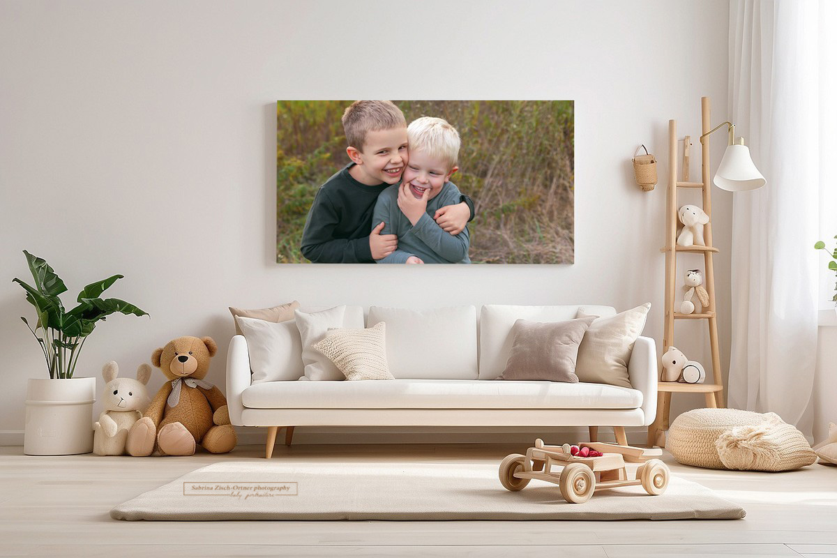Geschwisterfoto aus Familienfotoshooting mit Zisch Ortner groß im Wohnzimmer auf Leinwand gedruckt
